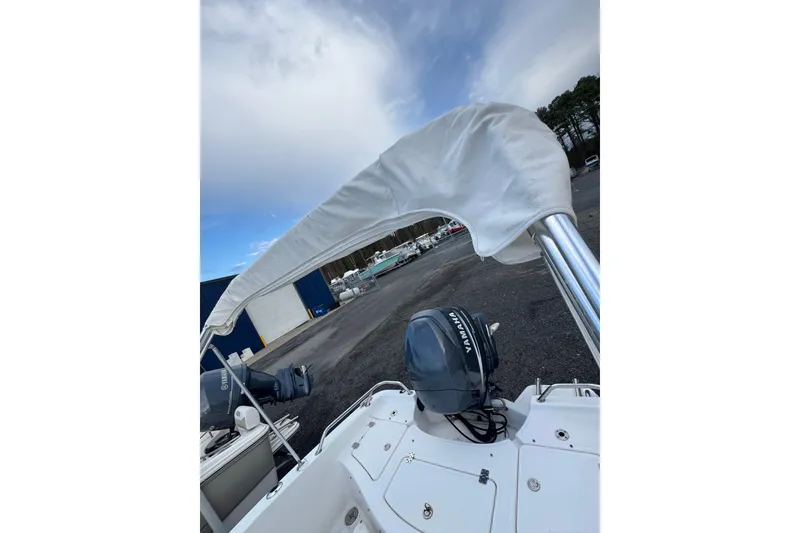 Slide: The Image of 2009 Pioneer 175 Venture boat with Yamaha motor and canopy, parked outdoors. - 16