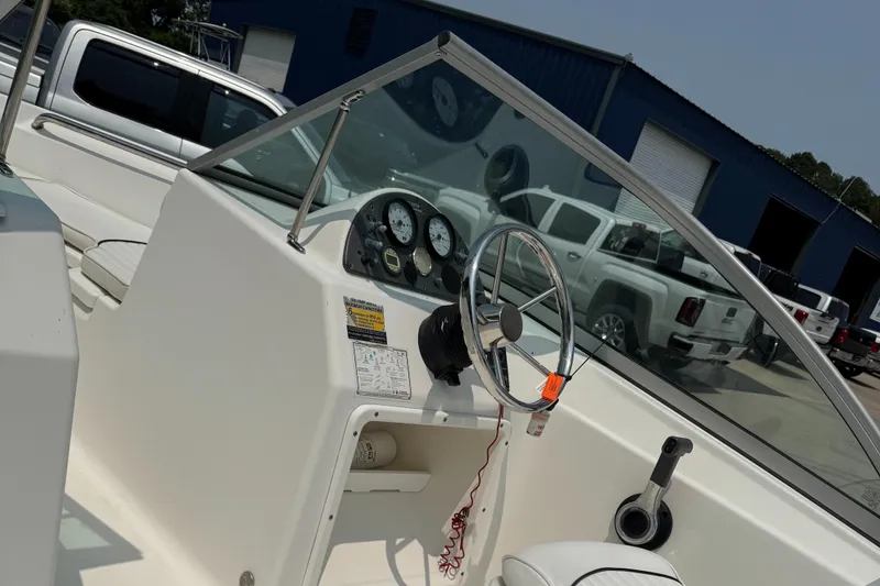 Slide: The Image of Interior view of a 2009 Pioneer 175 Venture boat with white seating. - 4