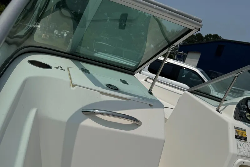 Slide: The Image of 2009 Pioneer 175 Venture boat interior with white cushioned seating. - 6