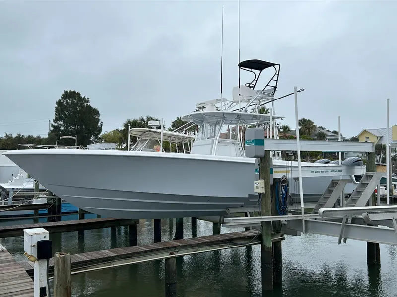 The Image of 2023 Contender 39 ST boat docked at marina, overcast sky, calm water. - 0