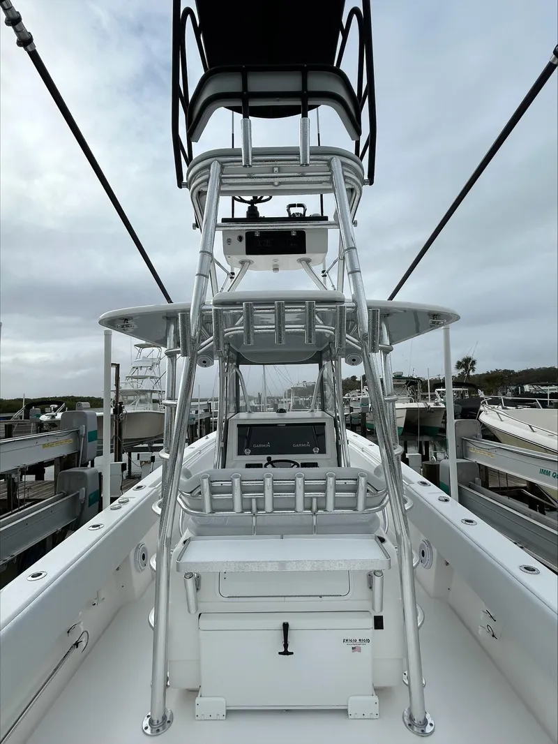 Slide: The Image of 2023 Contender 39 ST boat with tower, docked under cloudy skies. - 10