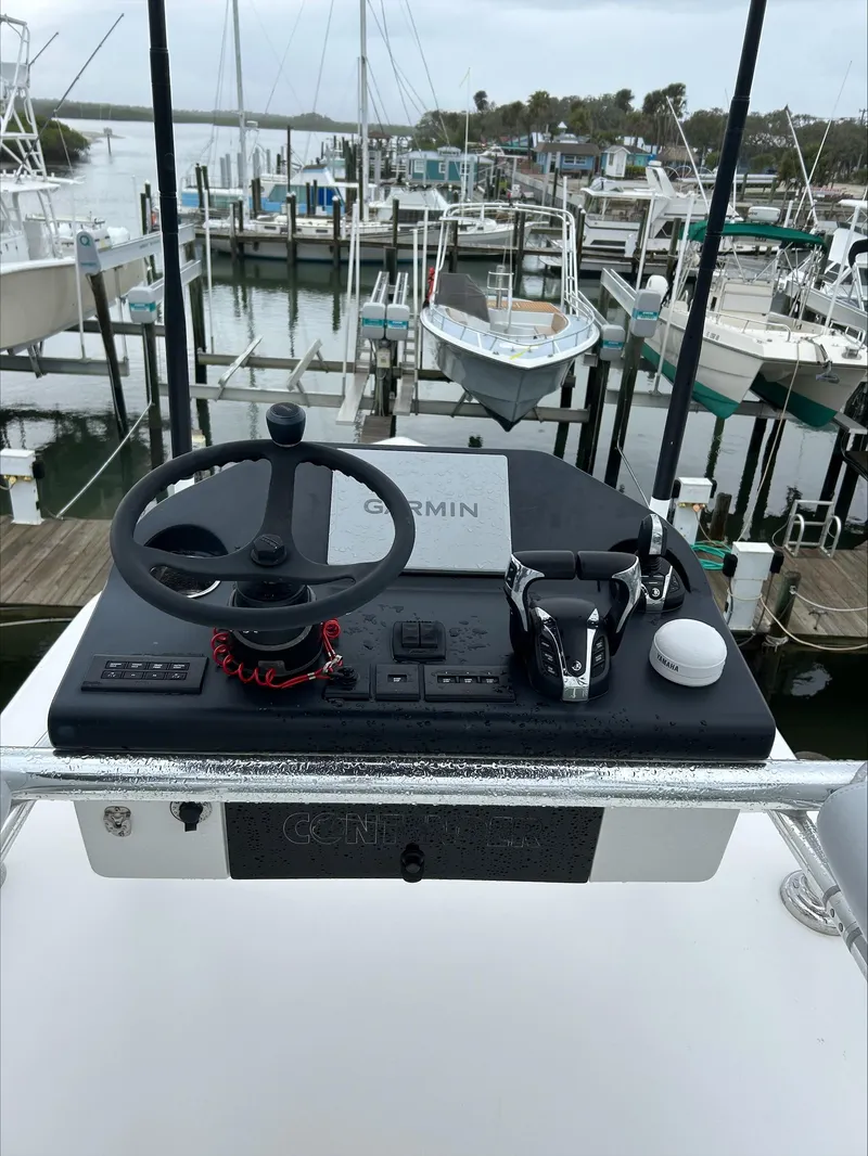 Slide: The Image of Helm of 2023 Contender 39 ST boat with Garmin navigation, docked at marina. - 12