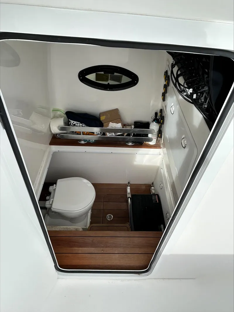 Slide: The Image of 2023 Contender 39 ST boat interior with toilet and storage area. - 13