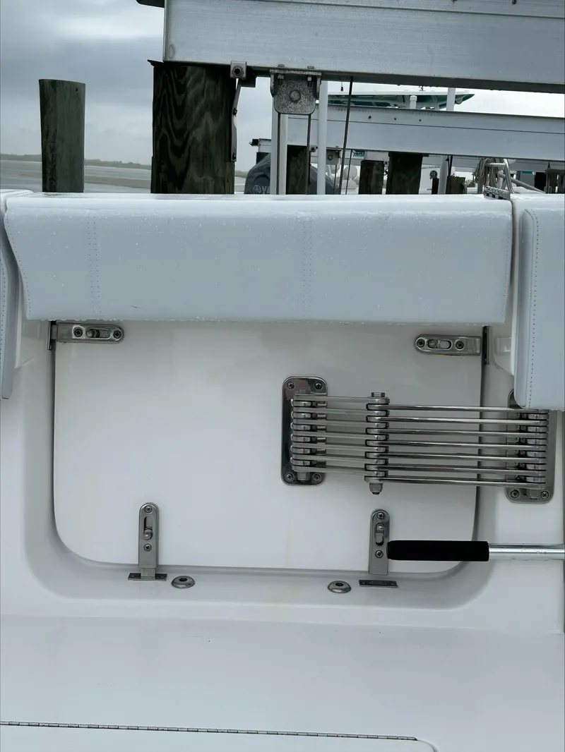 Slide: The Image of 2023 Contender 39 ST boat interior detail with sleek white seating and metal fixtures. - 14
