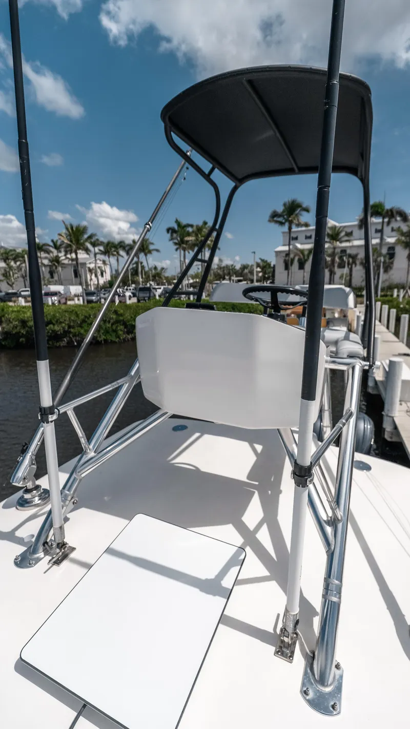 Slide: The Image of 2023 Contender 39 ST boat with sleek design, docked under a sunny sky. - 18