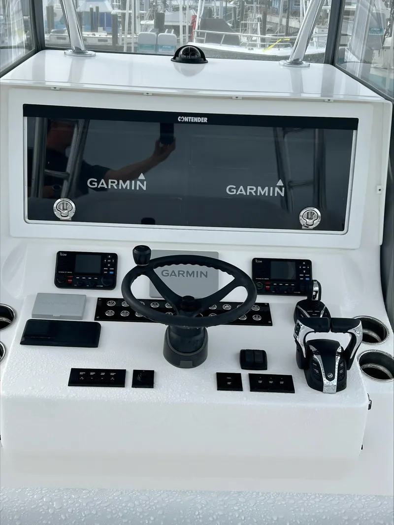 Slide: The Image of 2023 Contender 39 ST boat dashboard with Garmin navigation system. - 2