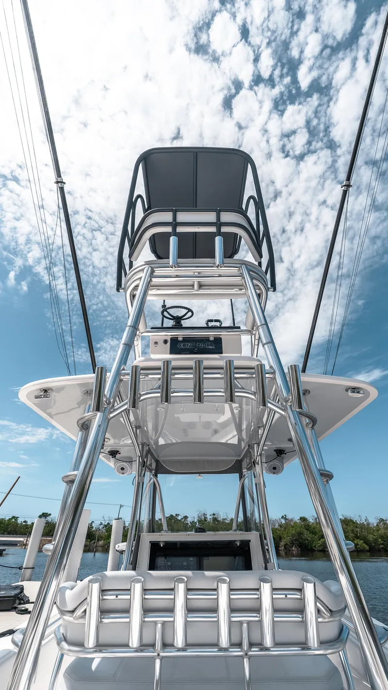 Slide: The Image of 2023 Contender 39 ST boat tower against a bright, cloudy sky. - 21