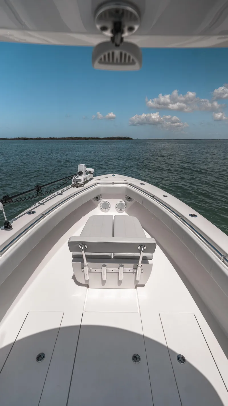 Slide: The Image of 2023 Contender 39 ST boat on open water under blue sky. - 23