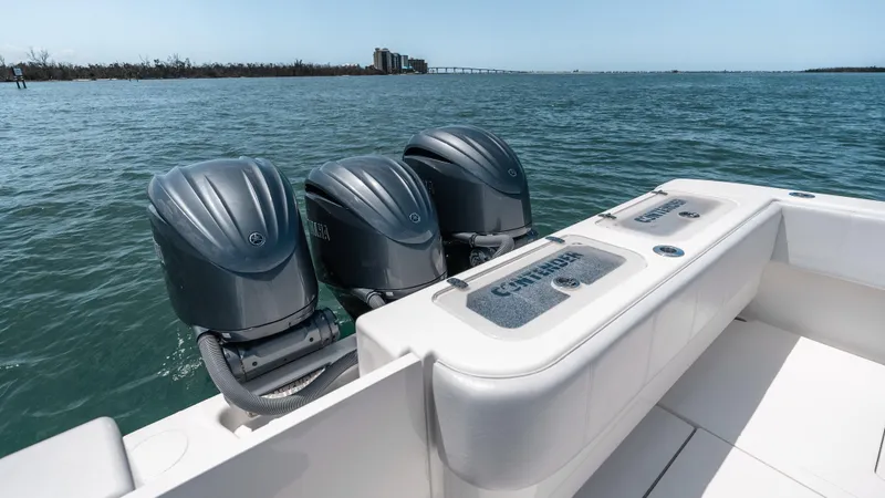Slide: The Image of 2023 Contender 39 ST boat with triple outboard engines on open water. - 27