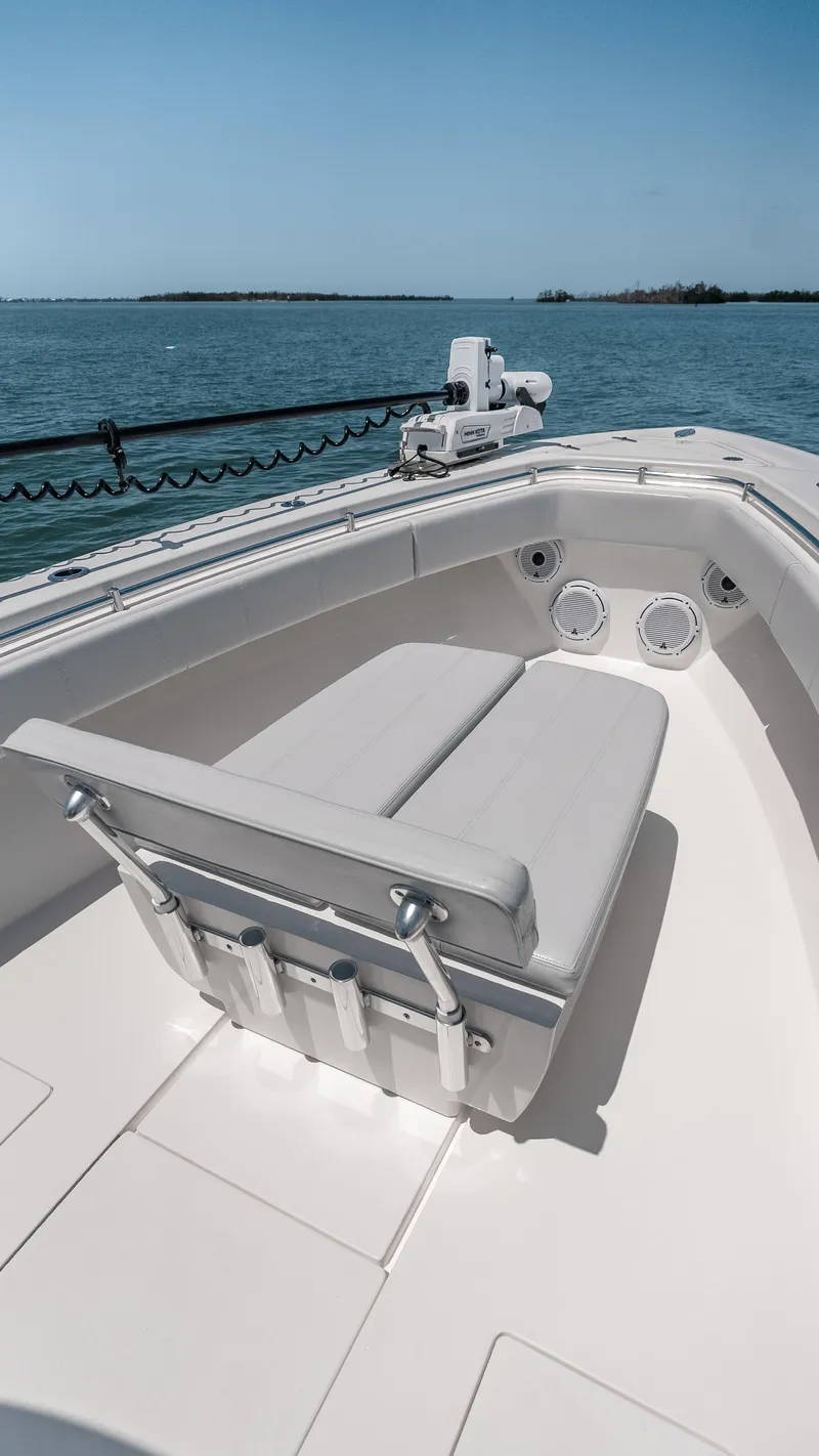 Slide: The Image of 2023 Contender 39 ST boat with cushioned seating, on calm waters. - 28