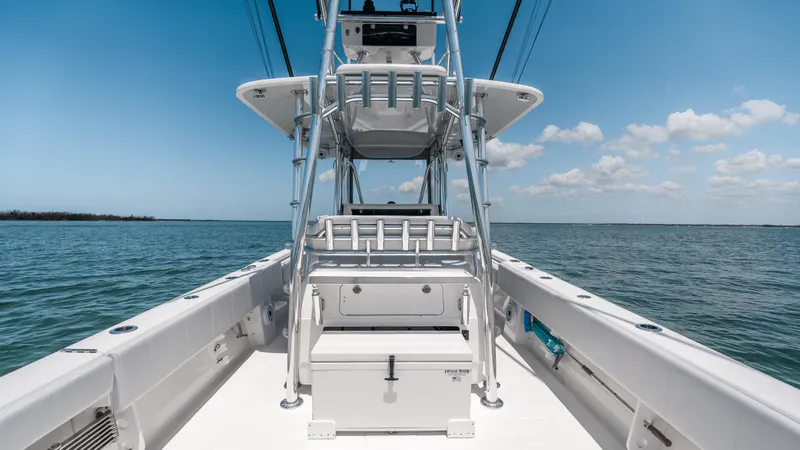 Slide: The Image of 2023 Contender 39 ST boat on open water under clear blue sky. - 31