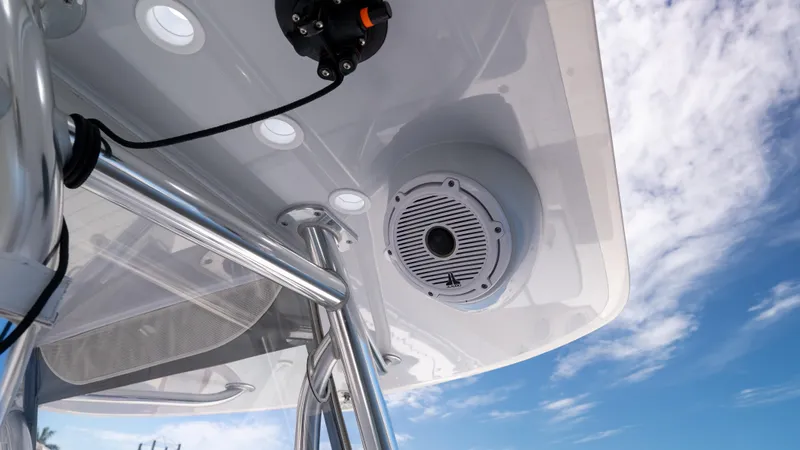 Slide: The Image of 2023 Contender 39 ST boat roof with speaker and metal supports against blue sky. - 33