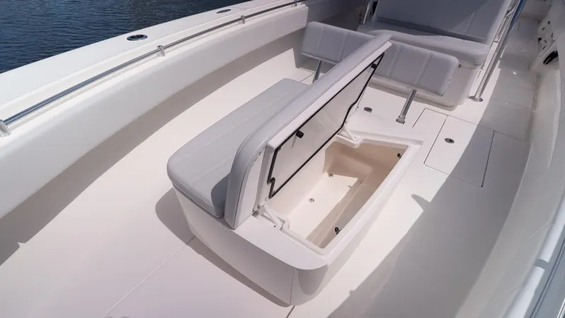 Slide: The Image of 2023 Contender 39 ST boat interior with open storage compartment and cushioned seating. - 35