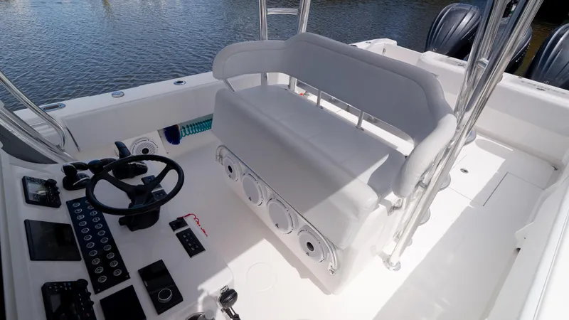 Slide: The Image of 2023 Contender 39 ST boat interior with steering wheel and seating, docked on water. - 36