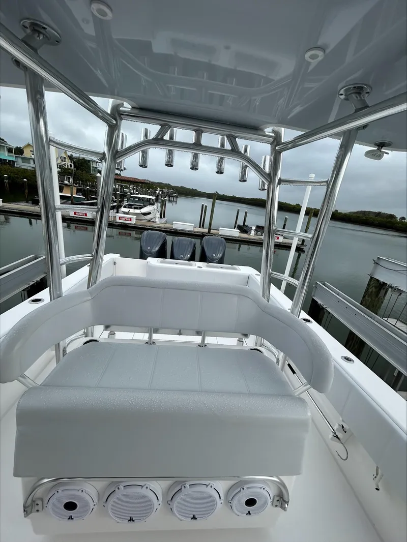 Slide: The Image of 2023 Contender 39 ST boat interior with seating and rod holders, docked at marina. - 6