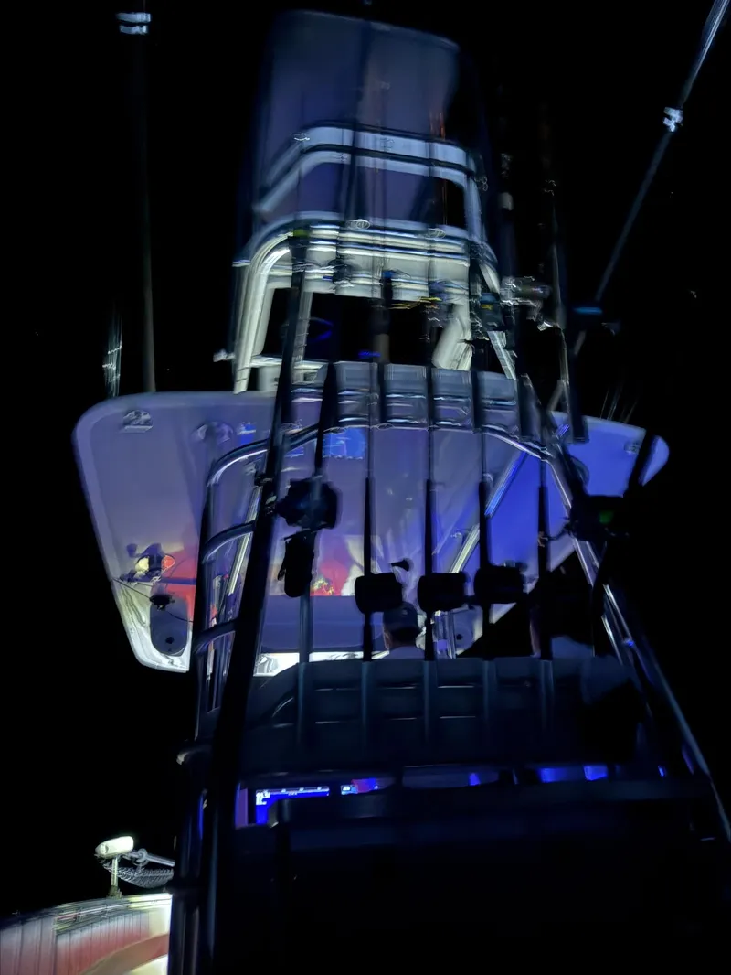 Slide: The Image of 2023 Contender 39 ST boat illuminated at night with fishing rods. - 8