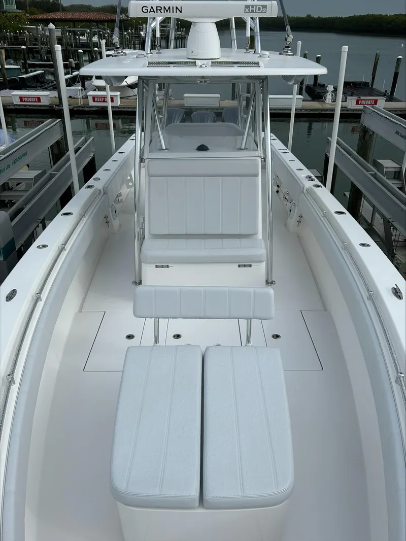 Slide: The Image of 2023 Contender 39 ST boat with sleek white seating and advanced navigation equipment. - 9
