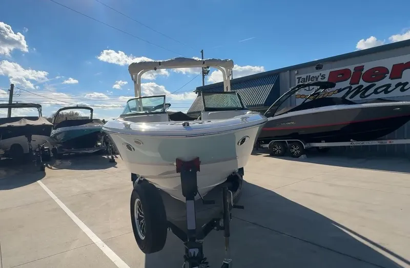 Slide: The Image of 2026 Regal LS2 Ultimate boat on trailer outside a shop. - 5