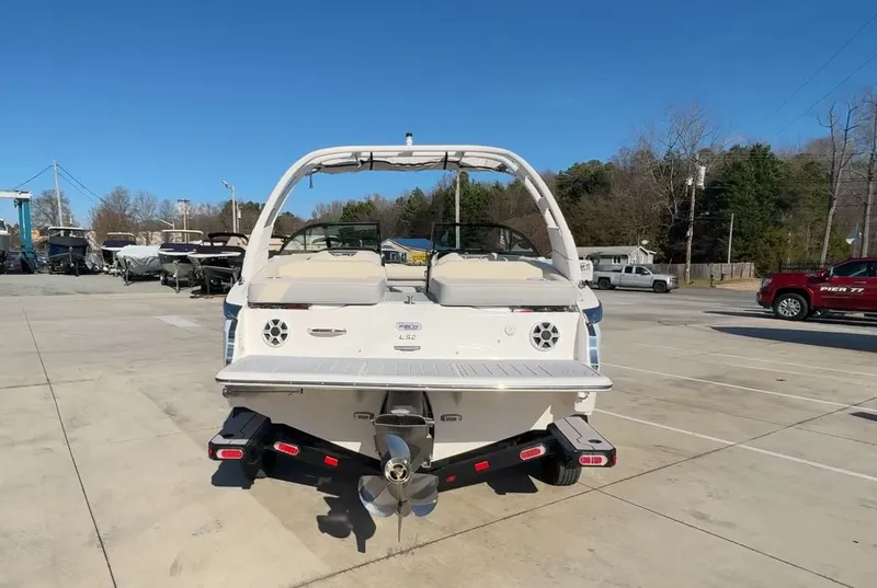 Slide: The Image of 2026 Regal LS2 Ultimate boat on trailer outdoors. - 8