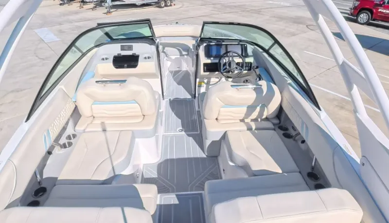Slide: The Image of Rear view of Regal LS2 Ultimate boat, 2026 model, in a parking lot. - 9