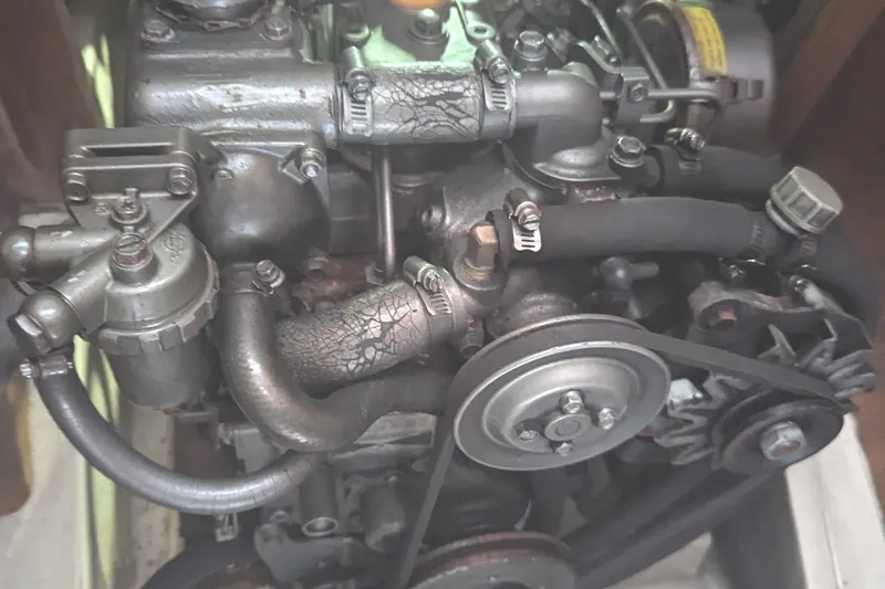 Slide: The Image of 2002 Hunter 326 engine with visible belts and hoses in a compact layout. - 15