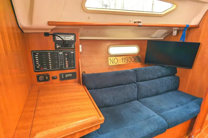 Slide: The Image of Interior of 2002 Hunter 326 sailboat with blue seating and control panel. - 20