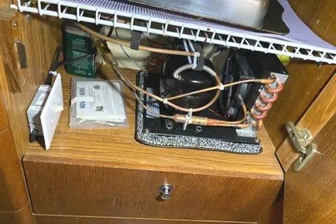 Slide: The Image of Electrical components inside a wooden cabinet of a 2002 Hunter 326 model. - 23