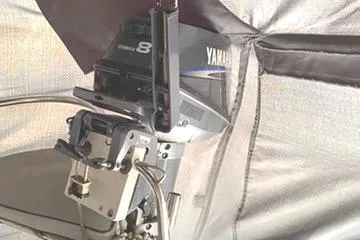 Slide: The Image of Outboard motor on a 2002 Hunter 326 sailboat, partially covered. - 24