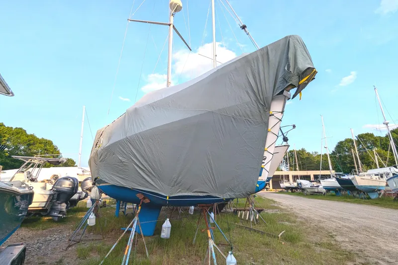 Slide: The Image of Covered 2002 Hunter 326 sailboat on stands in a boatyard. - 4