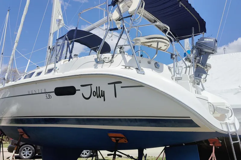 Slide: The Image of Sailboat "Jolly T," Hunter 326 model, 2002, on land with blue sky background. - 5
