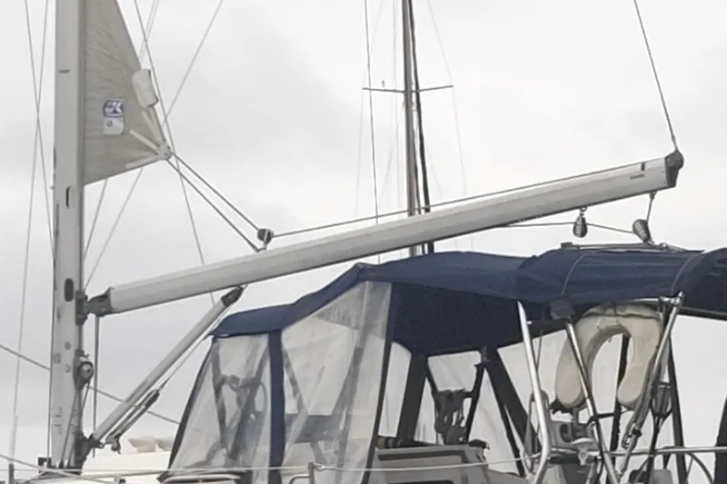 Slide: The Image of Sailboat with blue canopy, Hunter 326 model, 2002, docked under cloudy skies. - 9