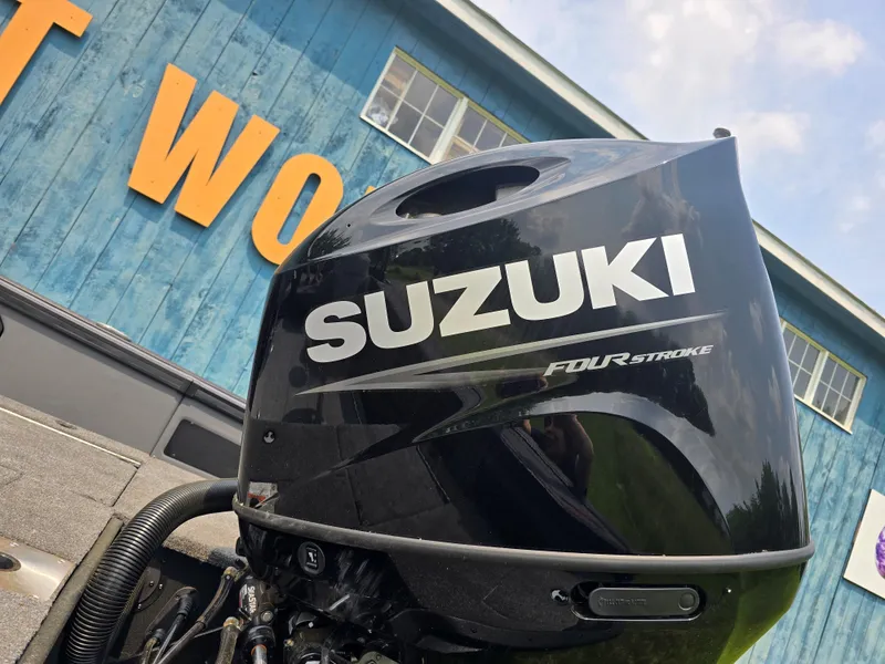 Slide: The Image of 2025 Alumacraft Trophy 185X with Suzuki four-stroke engine, outdoor setting. - 6