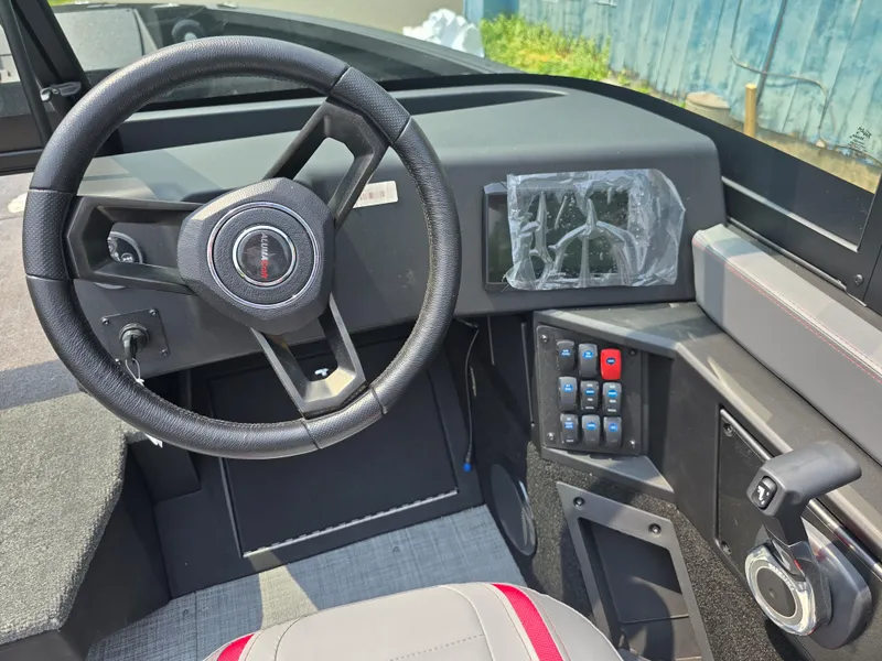 Slide: The Image of 2025 Alumacraft Trophy 185X SP FSX STD CV boat dashboard with steering wheel and control panel. - 8