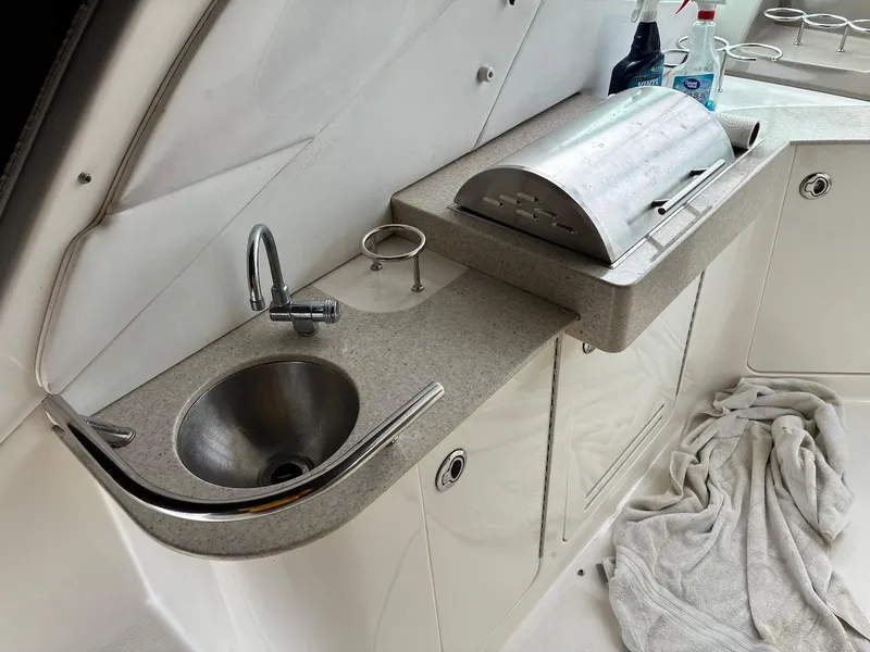 Slide: The Image of 2009 Sea Ray 330 Sundancer boat kitchenette with sink and grill. - 10