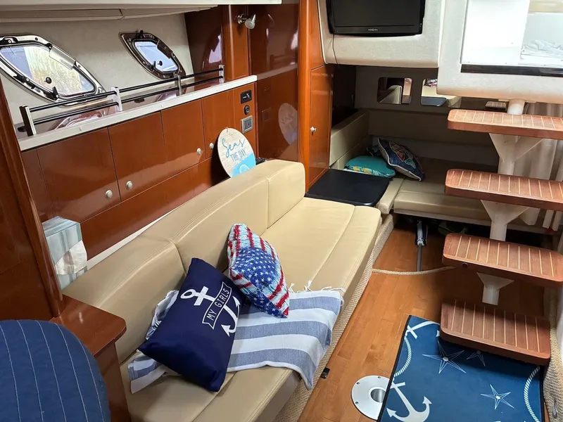 Slide: The Image of Interior of 2009 Sea Ray 330 Sundancer yacht with cozy seating and nautical decor. - 13