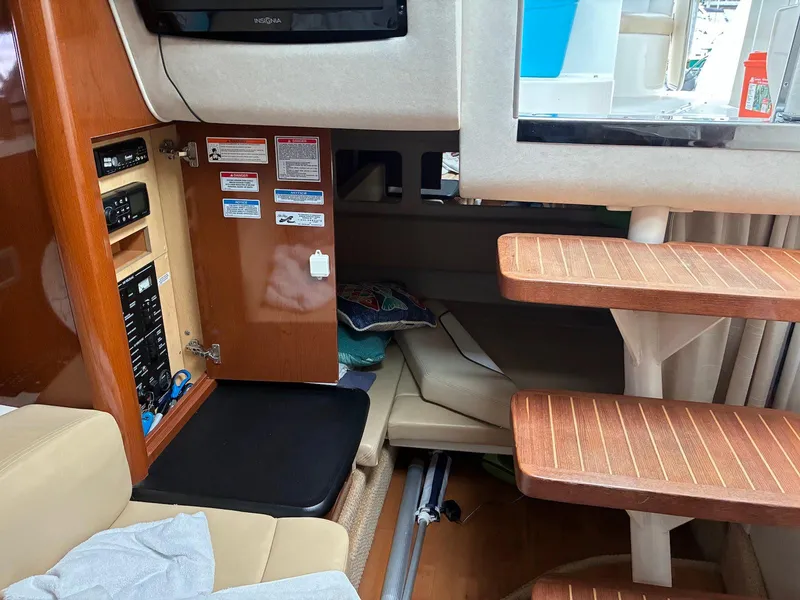 Slide: The Image of Interior of 2009 Sea Ray 330 Sundancer with wooden steps and control panel. - 15
