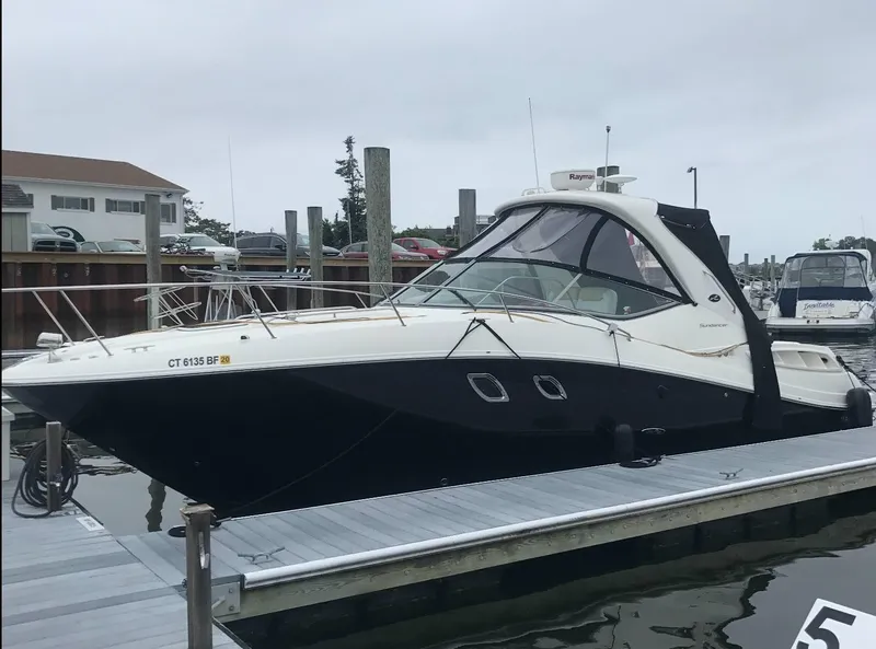 Slide: The Image of 2009 Sea Ray 330 Sundancer docked at a marina, overcast sky. - 2