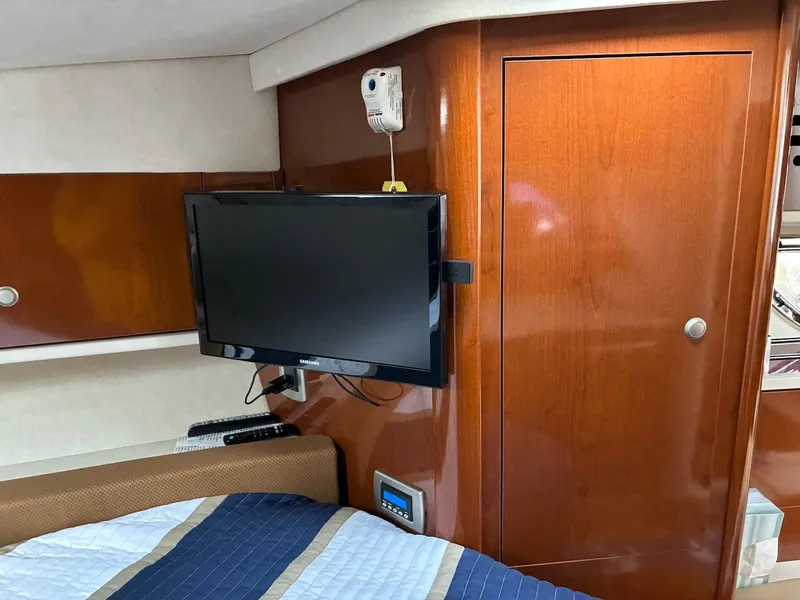 Slide: The Image of Interior of 2009 Sea Ray 330 Sundancer with TV and wooden cabinetry. - 22