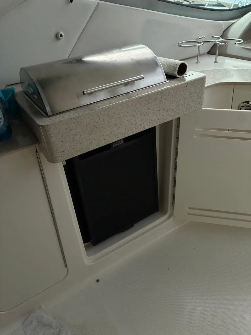 Slide: The Image of Outdoor kitchen area on a 2009 Sea Ray 330 Sundancer yacht with grill and storage. - 23