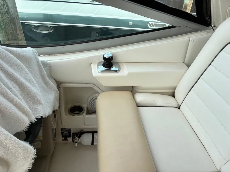 Slide: The Image of Interior of 2009 Sea Ray 330 Sundancer boat with white seating and control panel. - 25