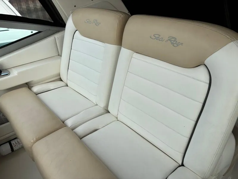 Slide: The Image of 2009 Sea Ray 330 Sundancer interior seating, featuring beige and white upholstery. - 26