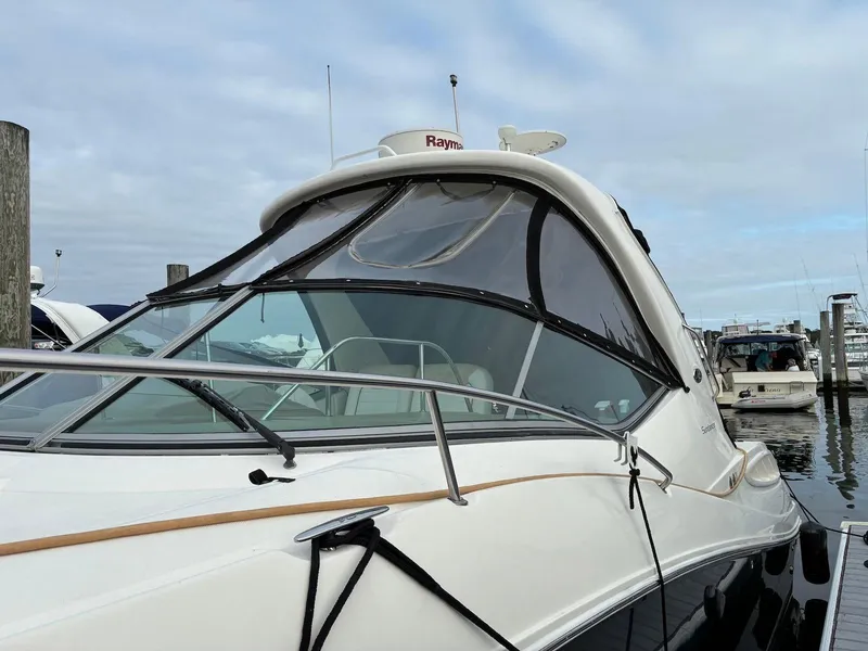 Slide: The Image of 2009 Sea Ray 330 Sundancer yacht docked at marina under cloudy sky. - 32