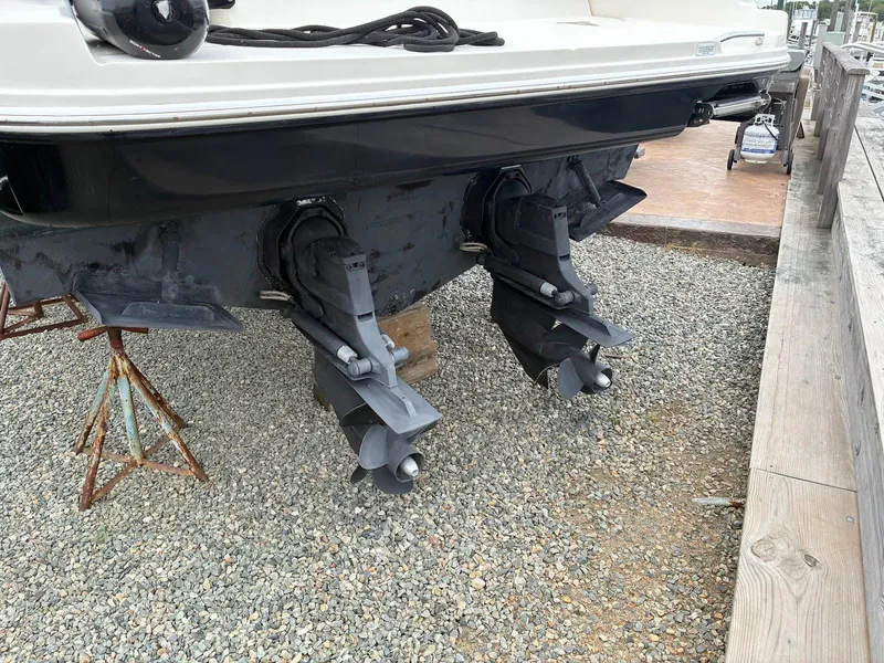 Slide: The Image of 2009 Sea Ray 330 Sundancer boat with dual outboard motors on gravel. - 34