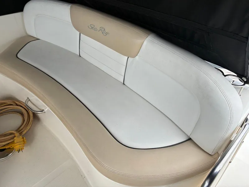 Slide: The Image of 2009 Sea Ray 330 Sundancer boat seating with beige and white upholstery. - 6