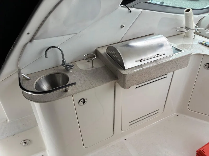 Slide: The Image of 2009 Sea Ray 330 Sundancer boat kitchenette with sink and grill. - 8