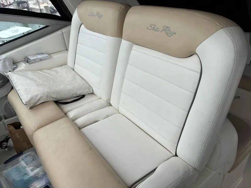 Slide: The Image of 2009 Sea Ray 330 Sundancer interior seating with beige and white upholstery. - 9