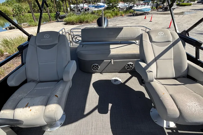 Slide: The Image of 2023 Regency 230 LE3 Sport boat interior with plush seating and modern design. - 5