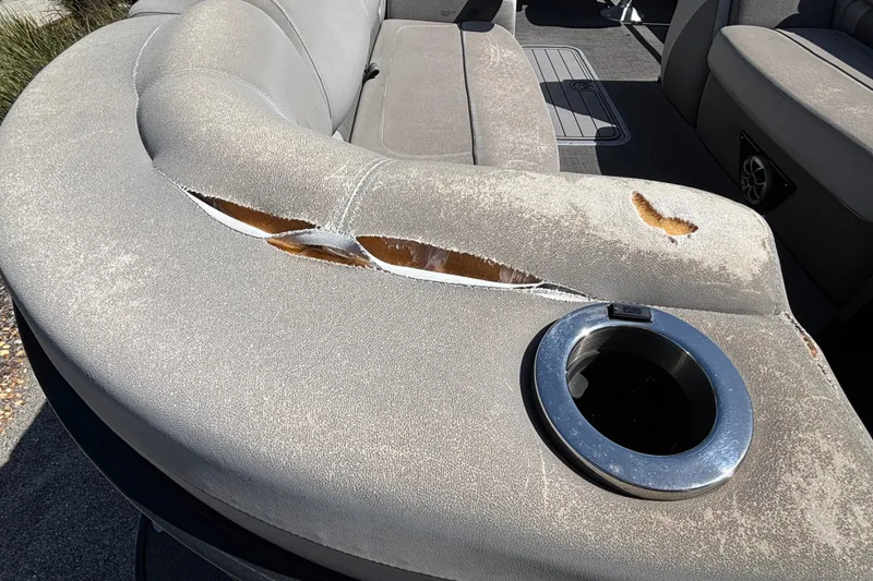 Slide: The Image of Damaged upholstery on 2023 Regency 230 LE3 Sport boat seat with cup holder. - 10