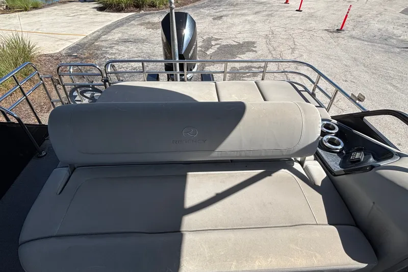 Slide: The Image of 2023 Regency 230 LE3 Sport boat interior with cushioned seating and cup holders. - 6