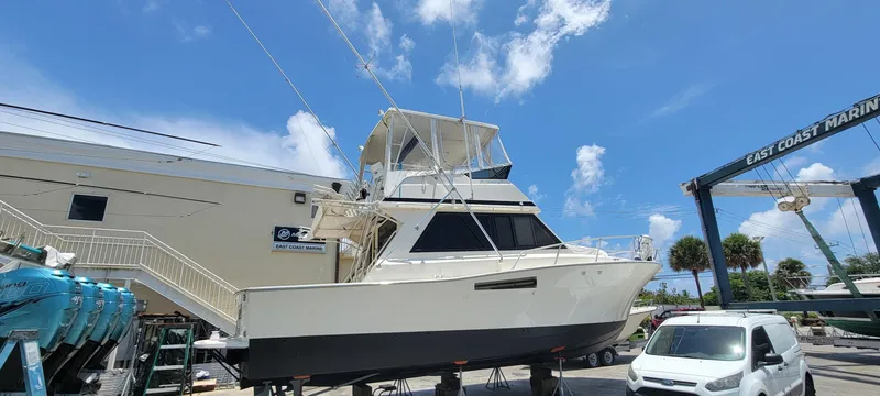 The Image of 1990 Viking 35 yacht on dry dock at East Coast Marine under a clear blue sky. - 0